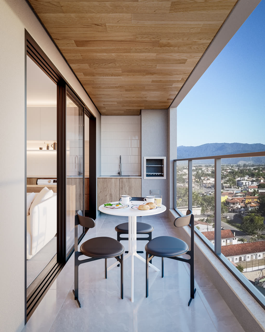 Varanda gourmet com churrasqueira e vista em apartamento do Cádiz Praia Clube, Caraguatatuba